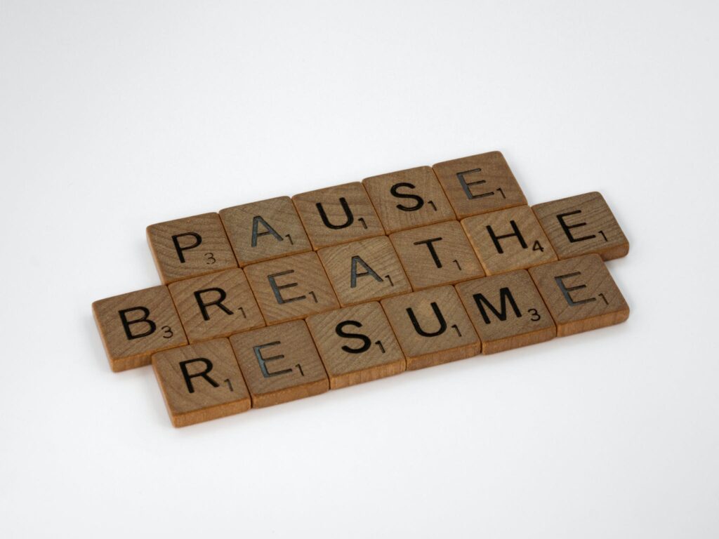 Brown Wooden Scrabble Pieces on White Surface